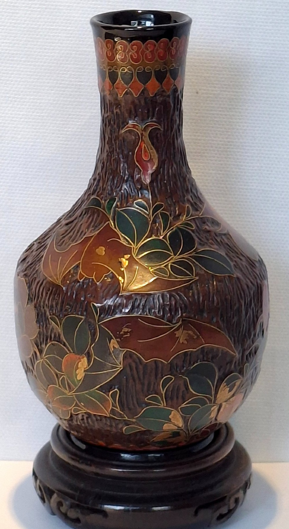 A dark brown Meiji period Japanese Totai Shippo ceramic vase displaying a textured tree bark surface decorated with cloisonne enamel bats and floral patterns.