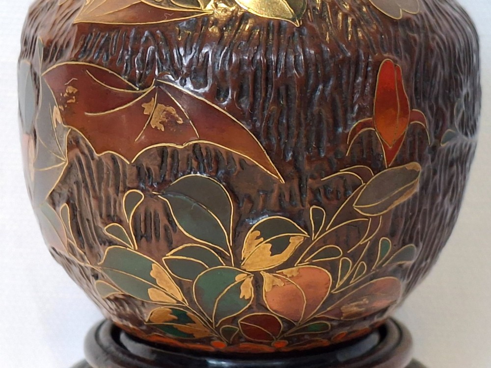 A dark brown Meiji period Japanese Totai Shippo ceramic vase displaying a textured tree bark surface decorated with cloisonne enamel bats and floral patterns. View IX