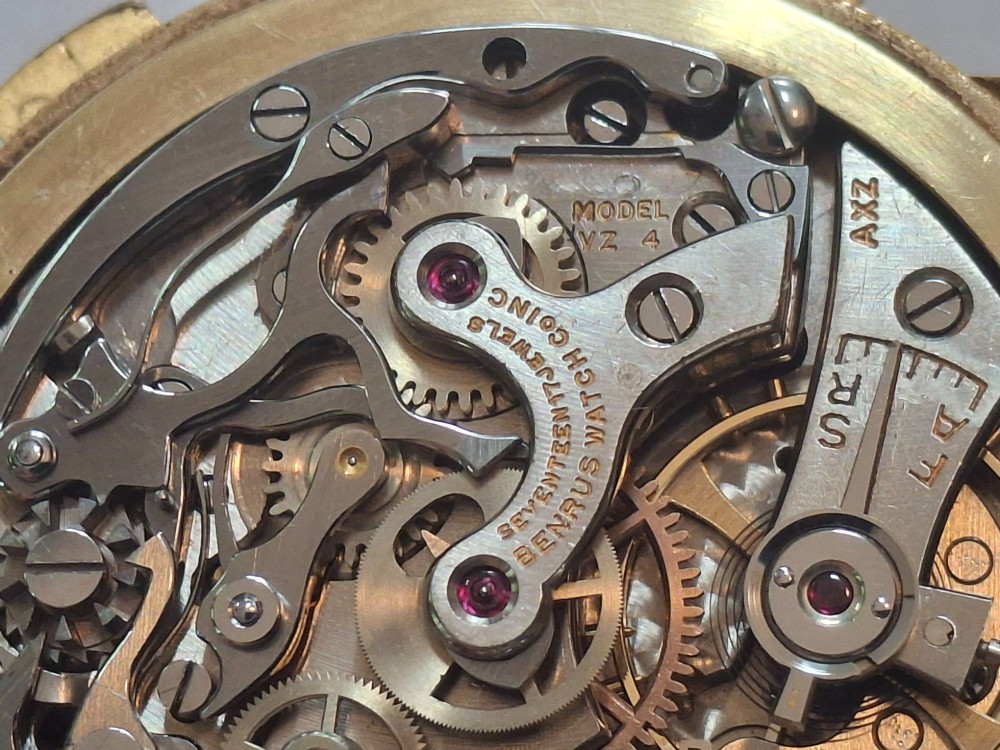 A 1940s Benrus Sky Chief gold chronograph wristwatch with a triple date display and dark brown leather strap. View X