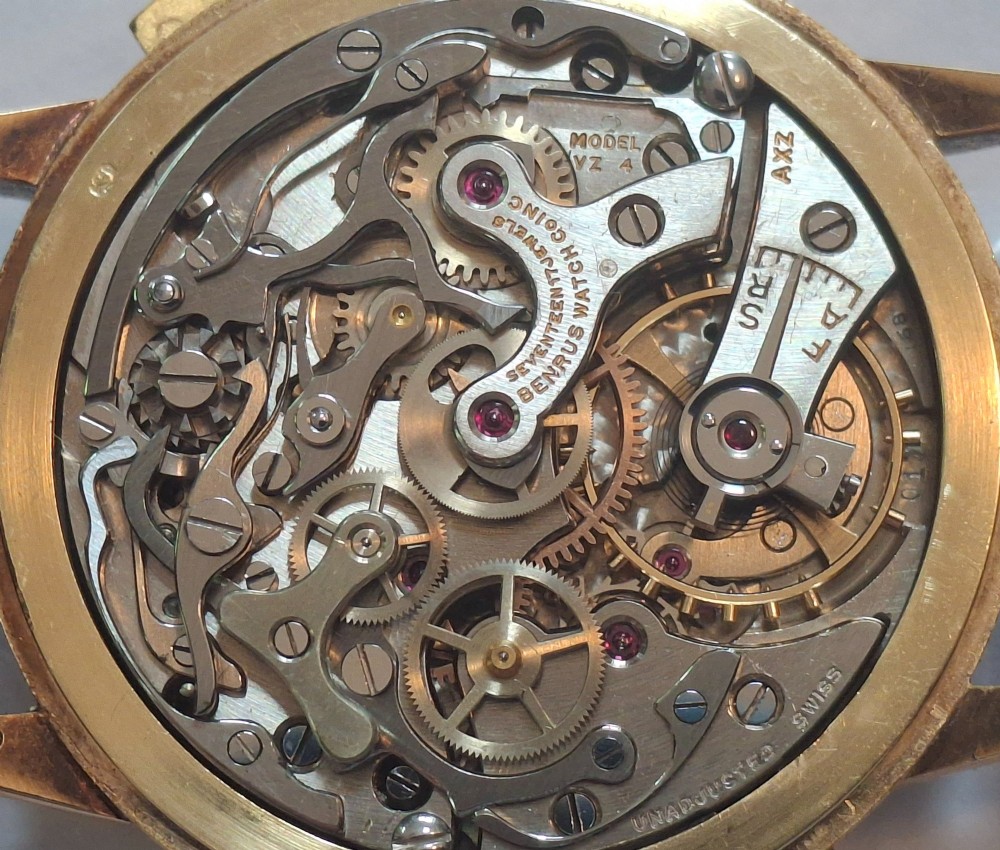 A 1940s Benrus Sky Chief gold chronograph wristwatch with a triple date display and dark brown leather strap. View XI