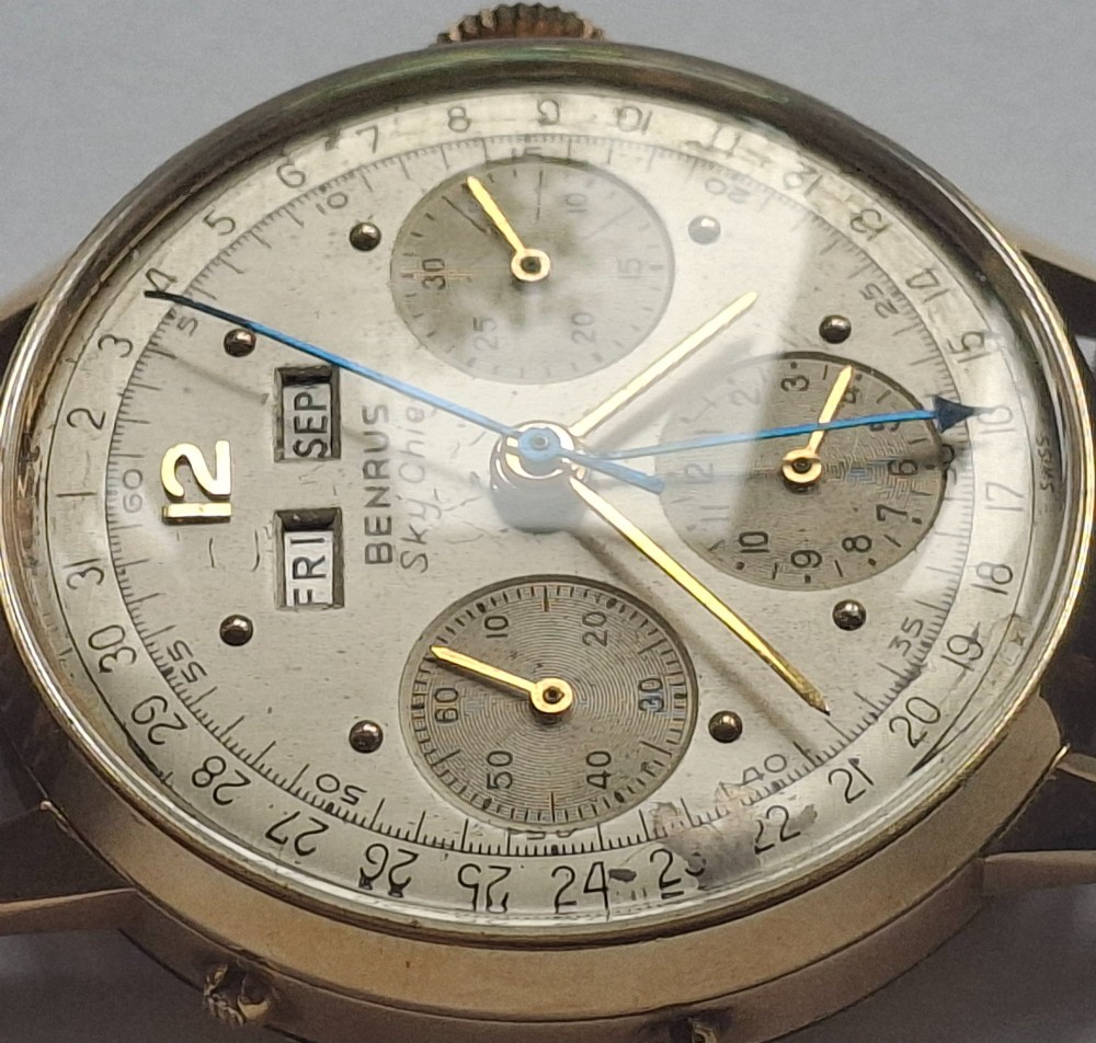 A 1940s Benrus Sky Chief gold chronograph wristwatch with a triple date display and dark brown leather strap. View XV
