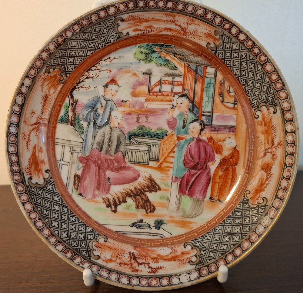 A hand-painted Chinese export porcelain coffee cup and matching saucer with polychrome figures and geometric diaper borders. View II