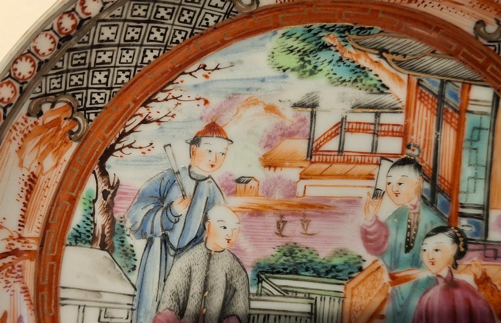 A hand-painted Chinese export porcelain coffee cup and matching saucer with polychrome figures and geometric diaper borders. View V