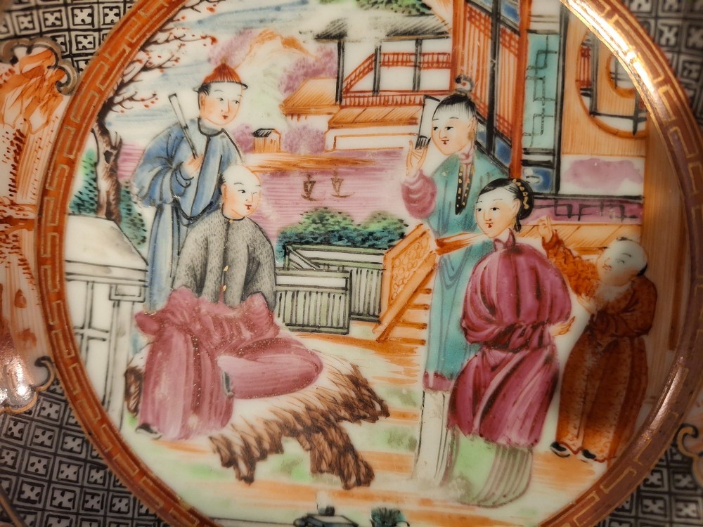 A hand-painted Chinese export porcelain coffee cup and matching saucer with polychrome figures and geometric diaper borders. View VI