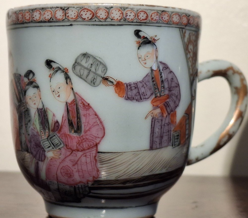 A hand-painted Chinese export porcelain coffee cup and matching saucer with polychrome figures and geometric diaper borders. View VII