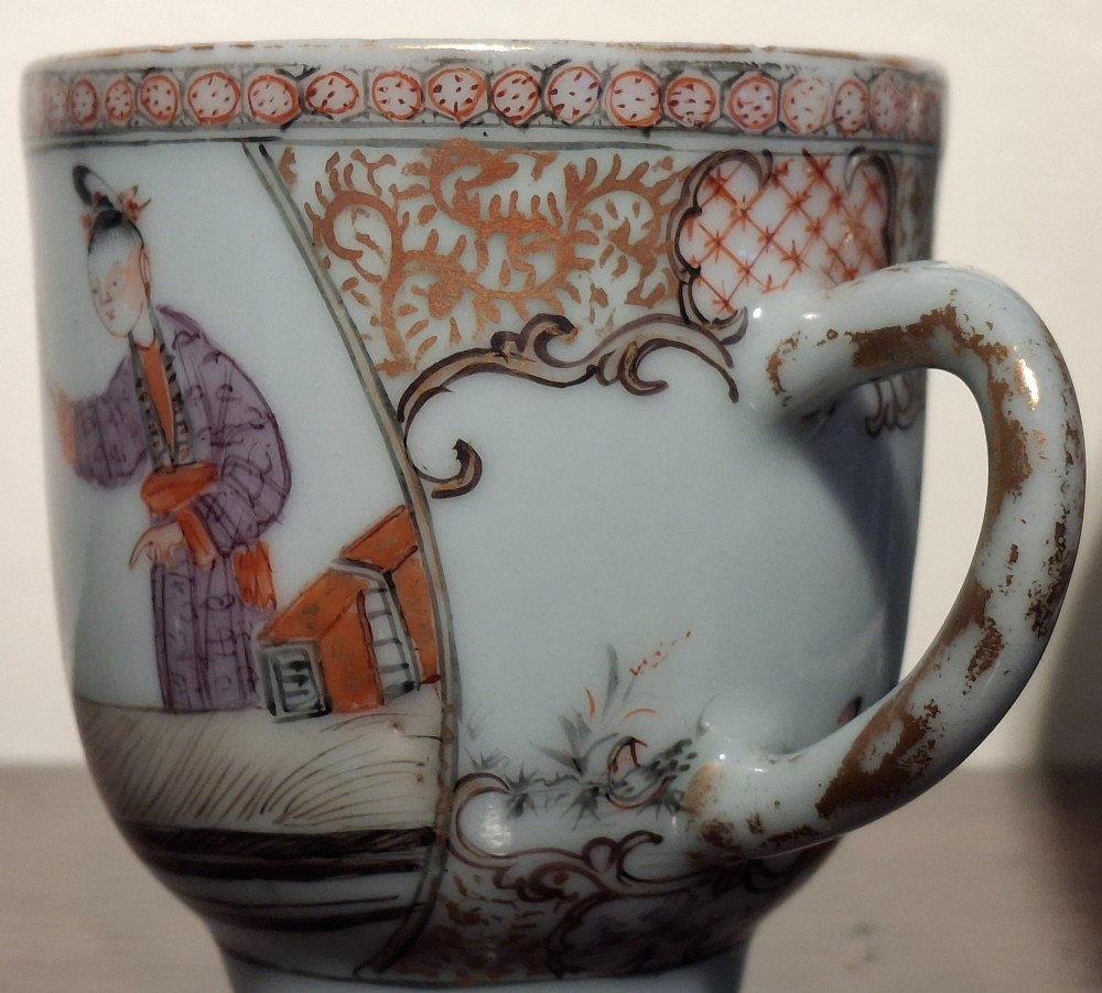 A hand-painted Chinese export porcelain coffee cup and matching saucer with polychrome figures and geometric diaper borders. View IX