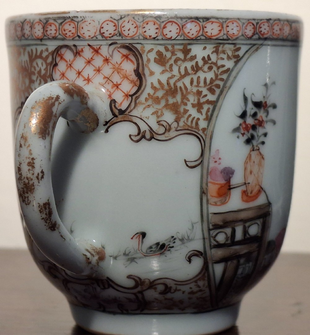 A hand-painted Chinese export porcelain coffee cup and matching saucer with polychrome figures and geometric diaper borders. View X