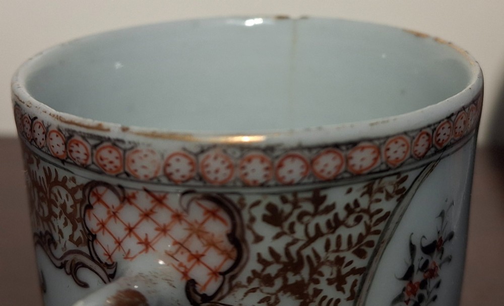 A hand-painted Chinese export porcelain coffee cup and matching saucer with polychrome figures and geometric diaper borders. View XIII