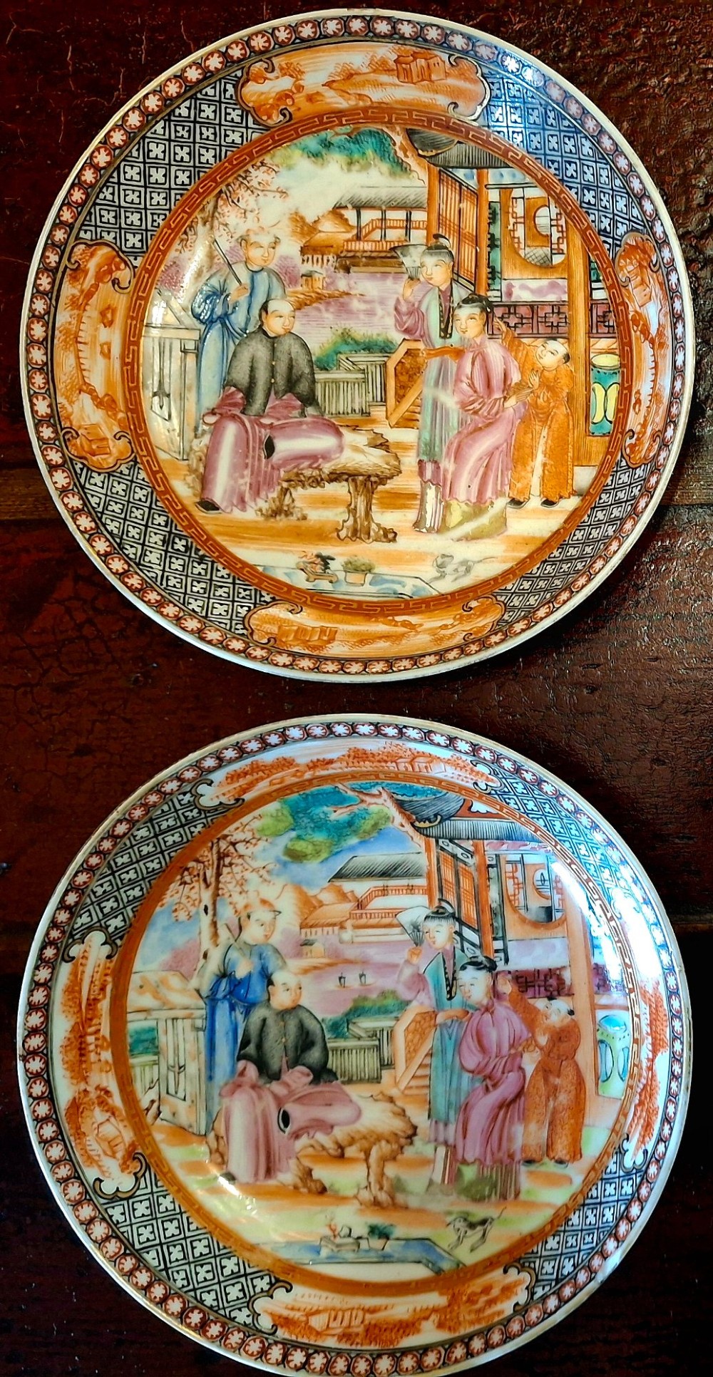 A set of four circular Chinese export porcelain saucers hand-painted with figural scenes inside pavilions framed by geometric borders in orange and polychrome enamels. View VIII