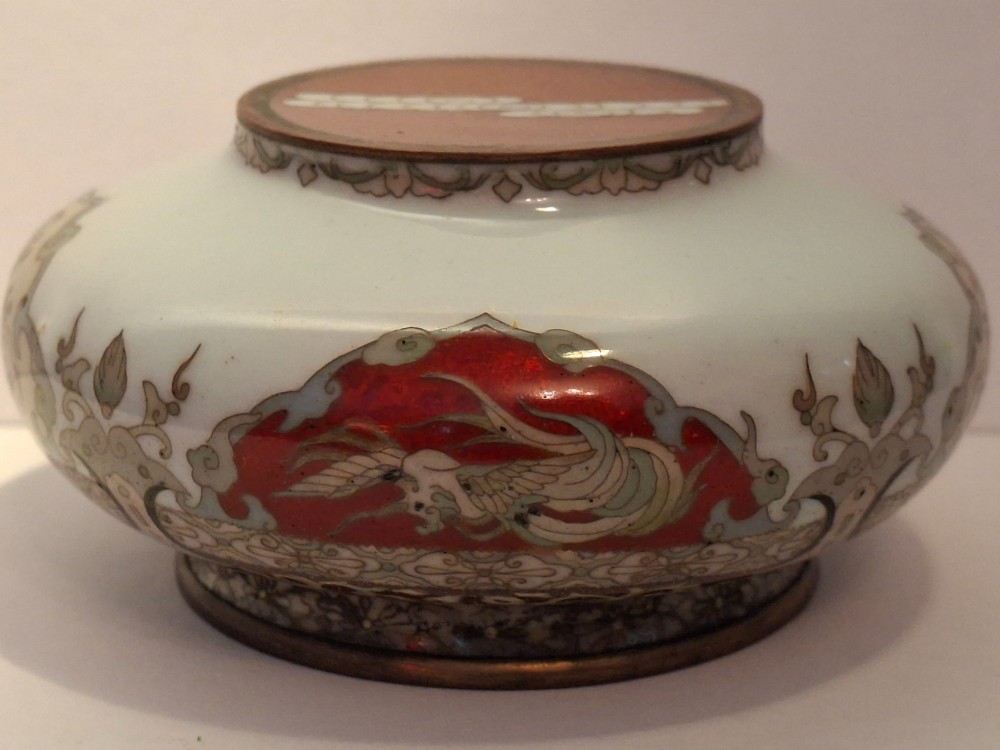 A Japanese cloisonne enamel koro decorated with phoenix motifs and intricate floral scrollwork, topped with a domed lid and carved finial. View XII