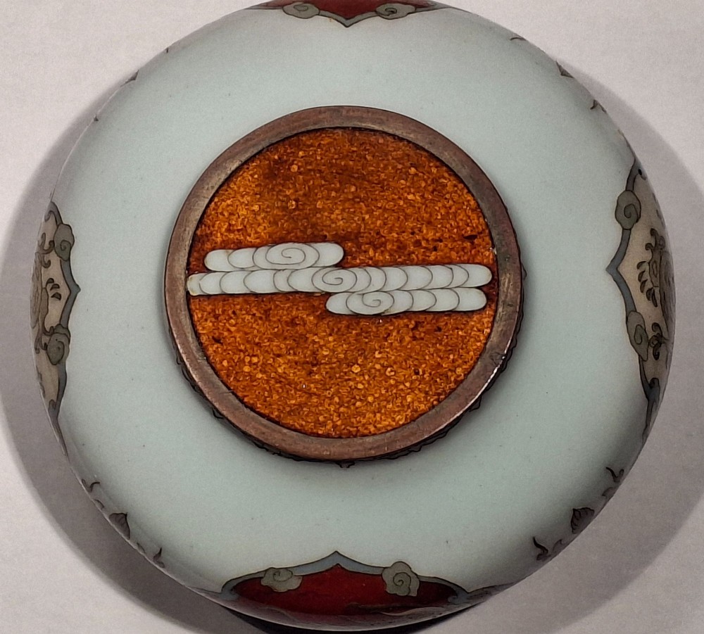 A Japanese cloisonne enamel koro decorated with phoenix motifs and intricate floral scrollwork, topped with a domed lid and carved finial. View XIV