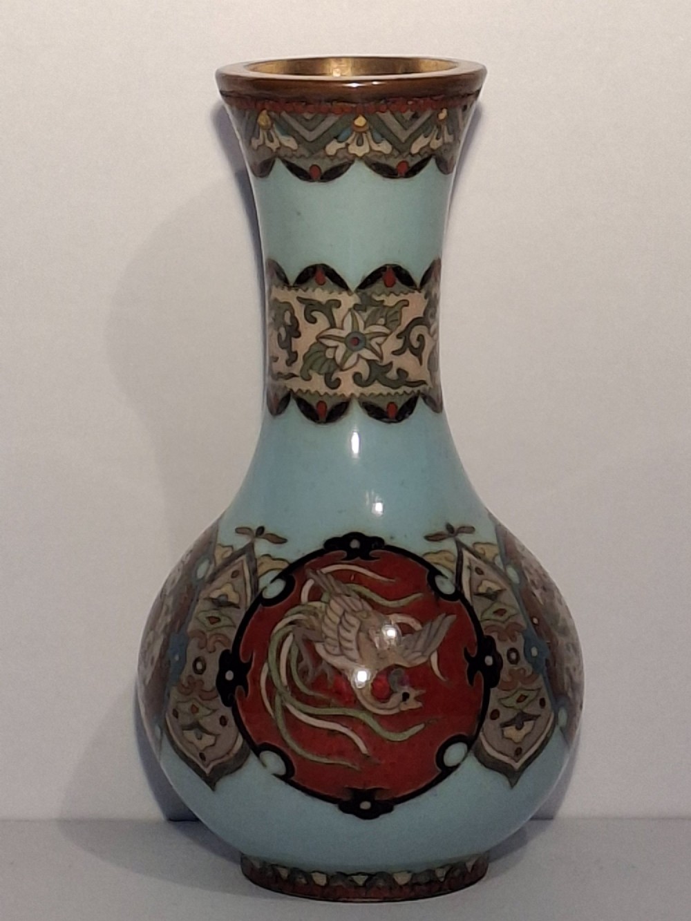 A pair of Japanese Meiji period cloisonne enamel miniature vases featuring detailed dragon and phoenix medallions on brown and light blue grounds. View VIII