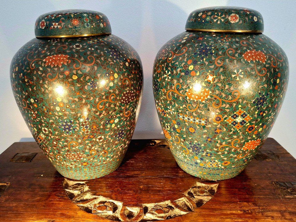 A pair of rounded Japanese cloisonne enamel ginger jars decorated with dense green foliage scrollwork and colourful floral motifs with domed lids. View III