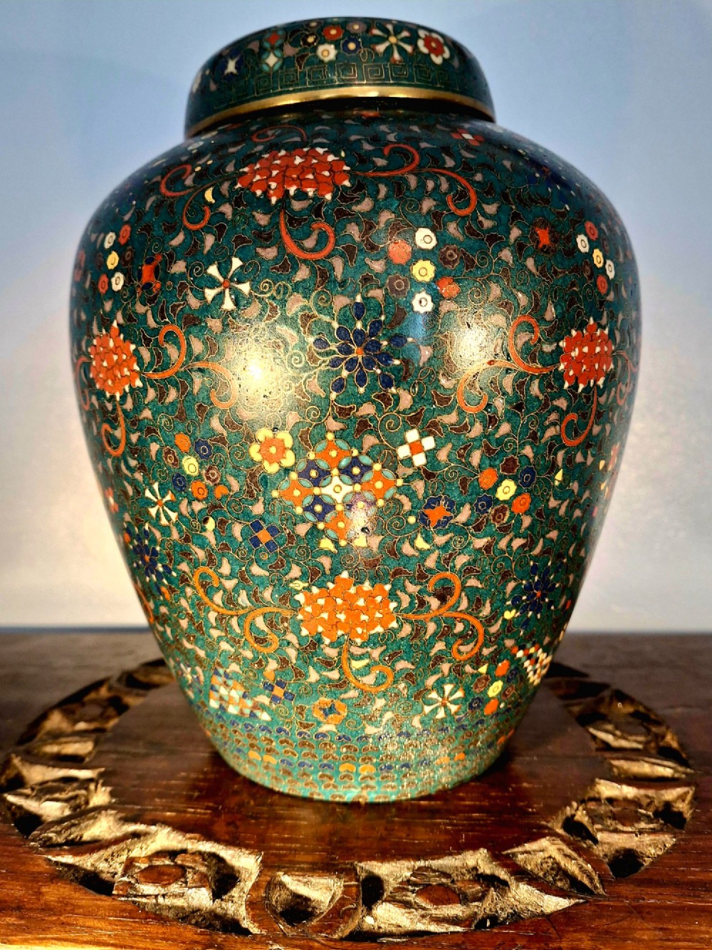 A pair of rounded Japanese cloisonne enamel ginger jars decorated with dense green foliage scrollwork and colourful floral motifs with domed lids. View XIV