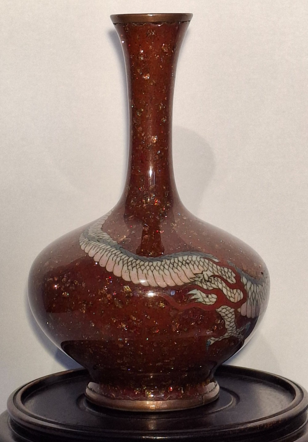A miniature dark red Japanese cloisonne enamel vase featuring a detailed coiled dragon motif and a slender neck. View IV