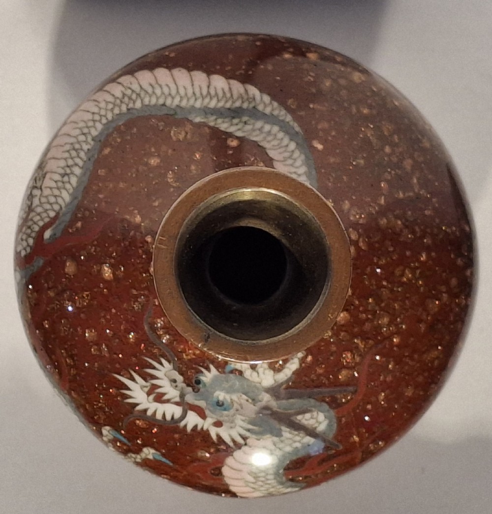 A miniature dark red Japanese cloisonne enamel vase featuring a detailed coiled dragon motif and a slender neck. View X