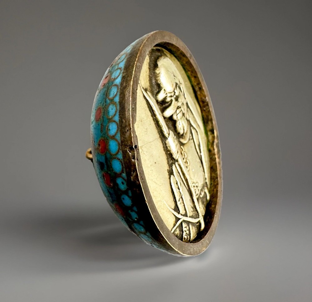 A domed Japanese cloisonne enamel ash receiver cover decorated with black scrollwork, turquoise patterned borders, red dots, and a brass top loop. View III