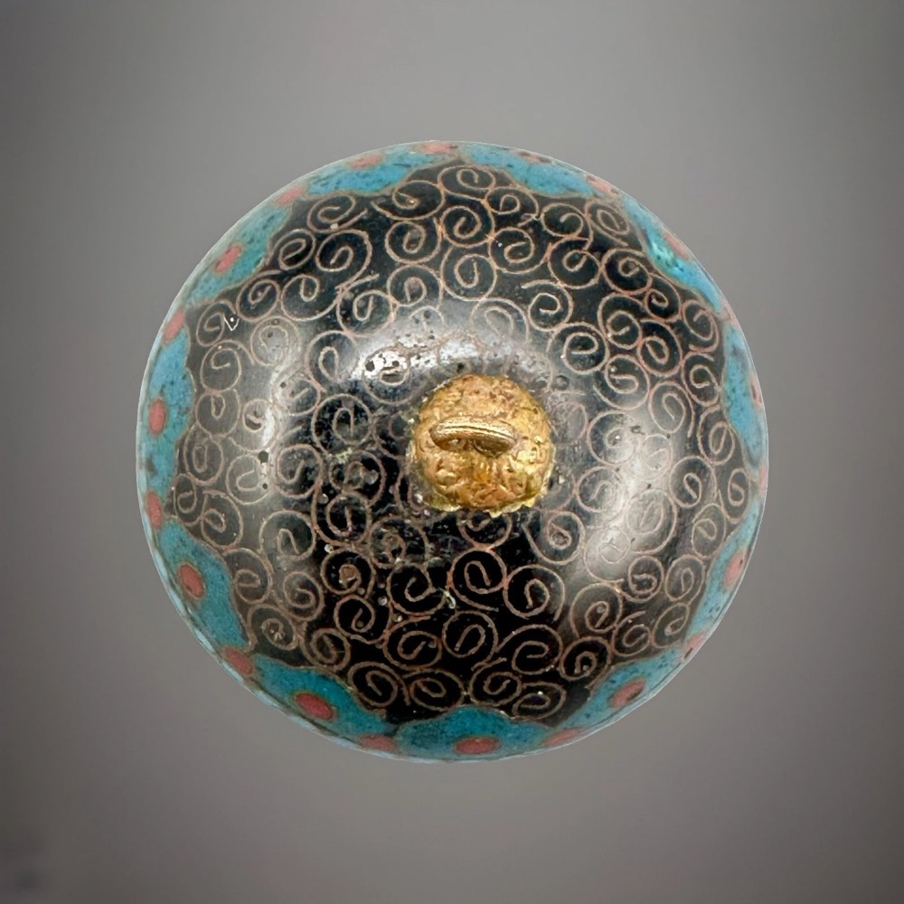 A domed Japanese cloisonne enamel ash receiver cover decorated with black scrollwork, turquoise patterned borders, red dots, and a brass top loop. View VII