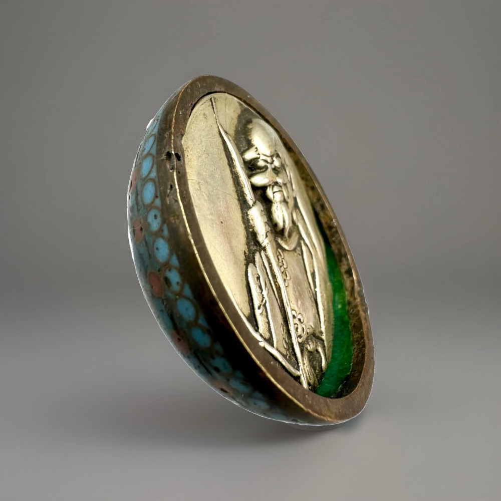 A domed Japanese cloisonne enamel ash receiver cover decorated with black scrollwork, turquoise patterned borders, red dots, and a brass top loop. View VIII