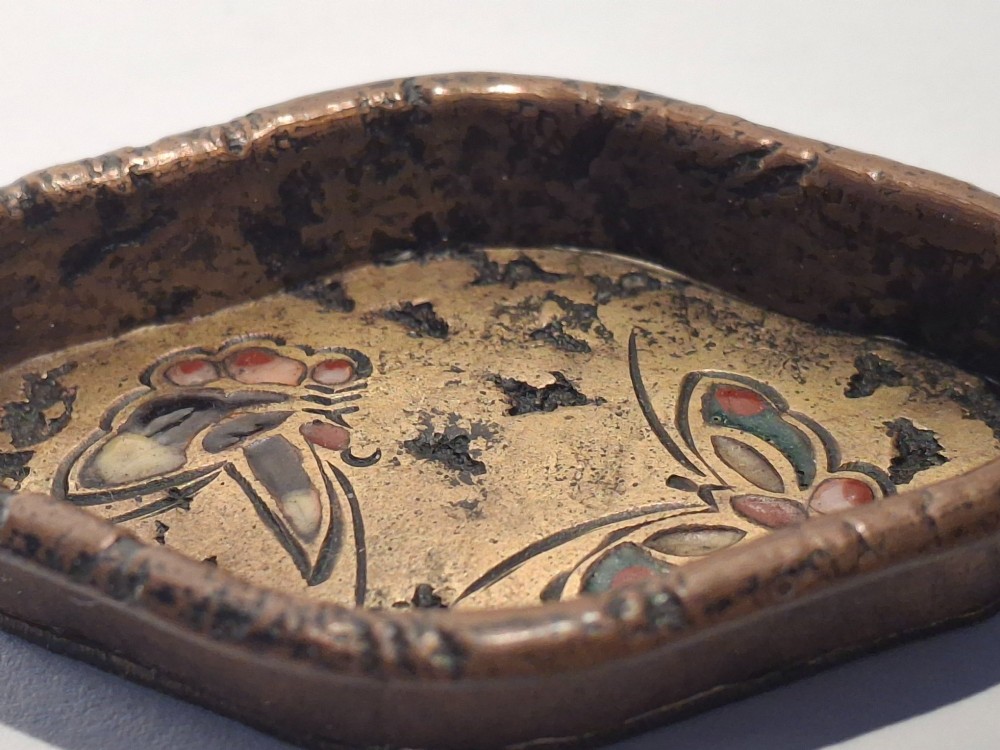 An oval-shaped antique Japanese bronze recessed door pull featuring two decorative enamel butterflies against a textured gilded background. View VIII