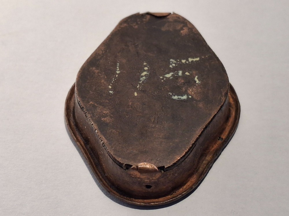 An oval-shaped antique Japanese bronze recessed door pull featuring two decorative enamel butterflies against a textured gilded background. View IX