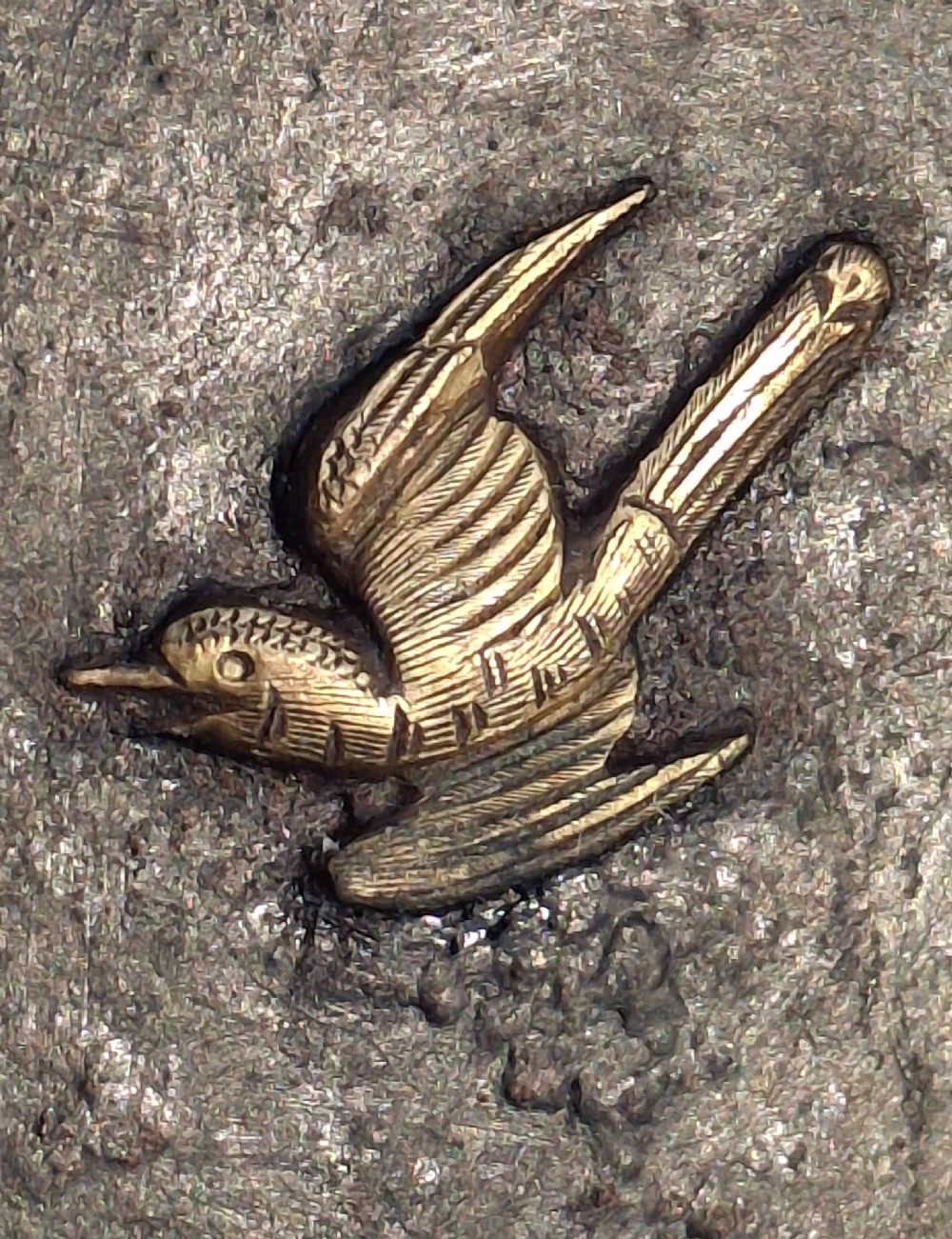 A rectangular dark bronze recessed Japanese hikite door pull decorated with a gilt bird in flight and carved pine tree motifs. View VI