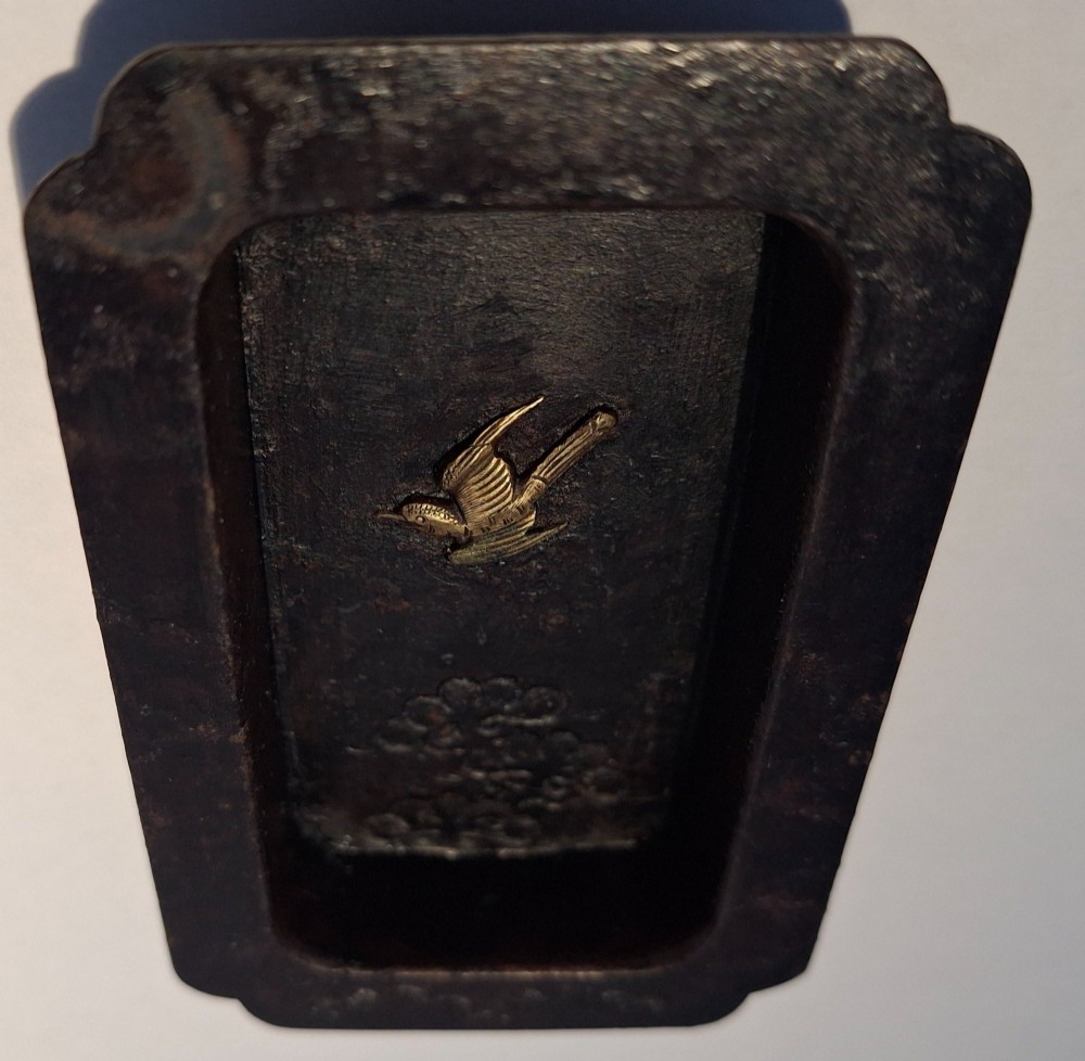 A rectangular dark bronze recessed Japanese hikite door pull decorated with a gilt bird in flight and carved pine tree motifs. View IX