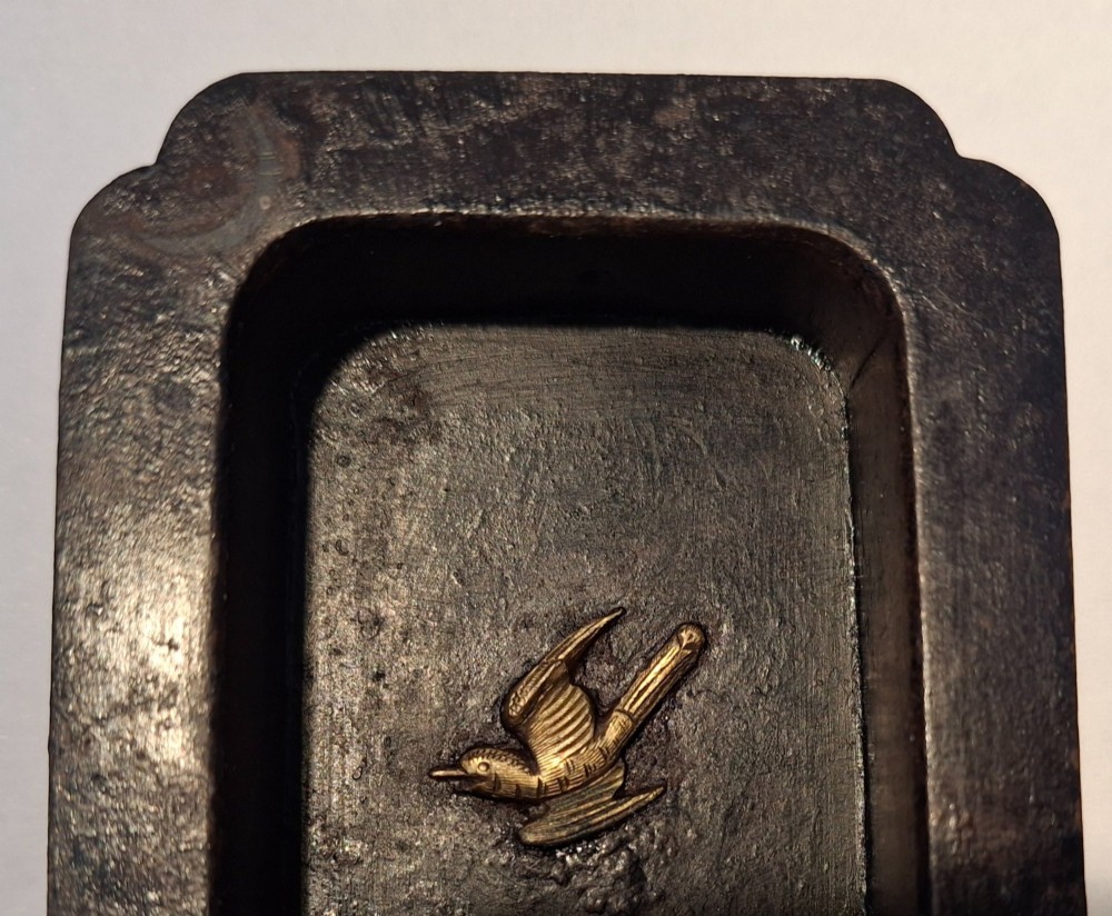A rectangular dark bronze recessed Japanese hikite door pull decorated with a gilt bird in flight and carved pine tree motifs. View X
