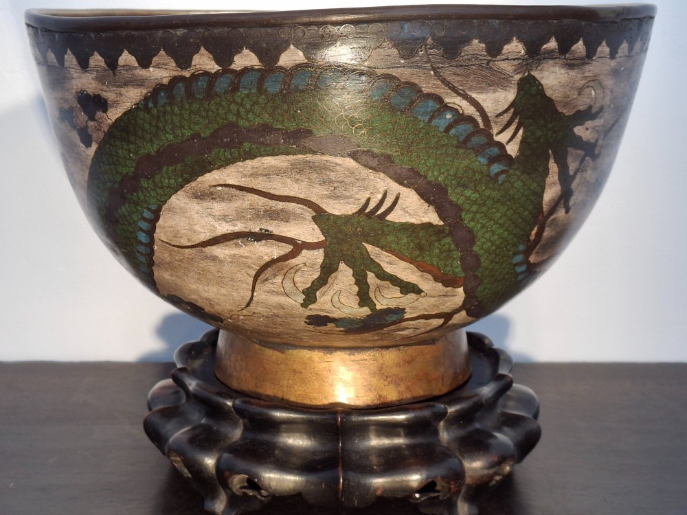 A large Japanese cloisonne enamel bowl featuring green dragon motifs, displayed on a carved dark wooden stand. View IV