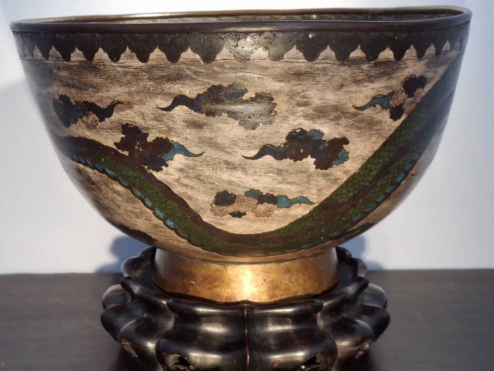 A large Japanese cloisonne enamel bowl featuring green dragon motifs, displayed on a carved dark wooden stand. View VI