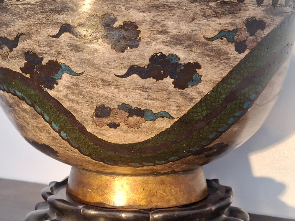 A large Japanese cloisonne enamel bowl featuring green dragon motifs, displayed on a carved dark wooden stand. View IX