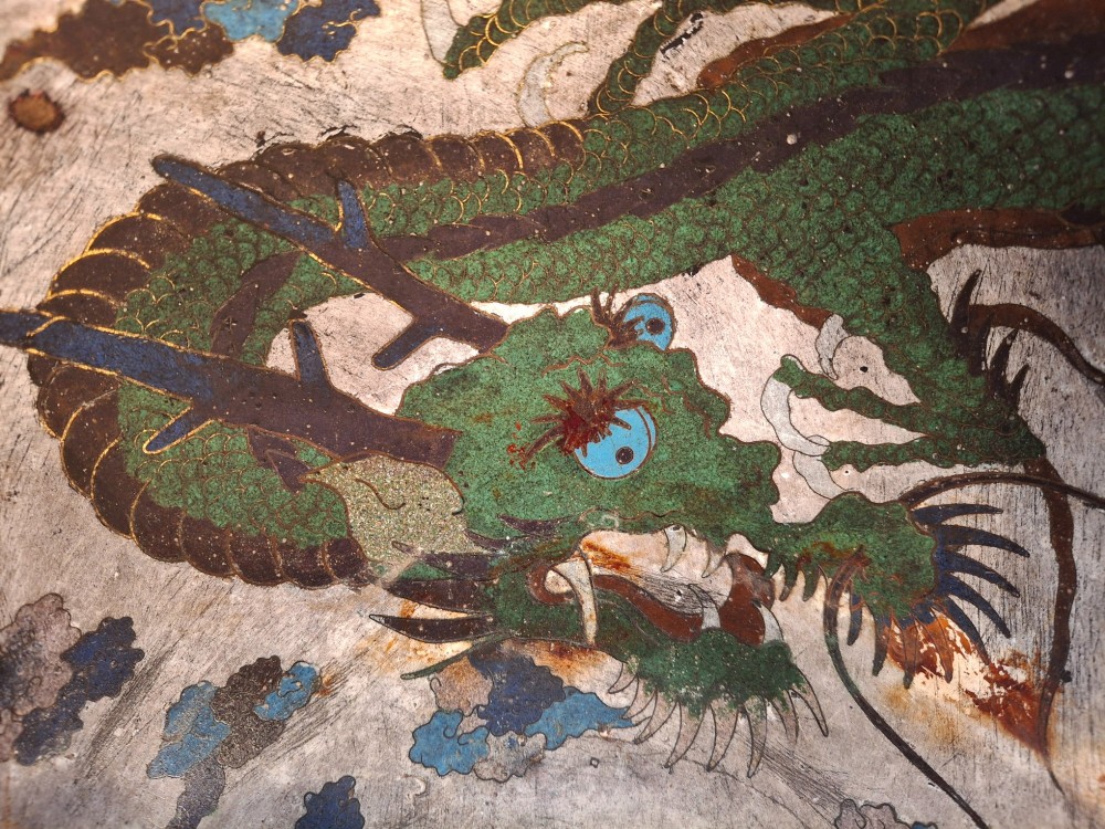 A large Japanese cloisonne enamel bowl featuring green dragon motifs, displayed on a carved dark wooden stand. View XII