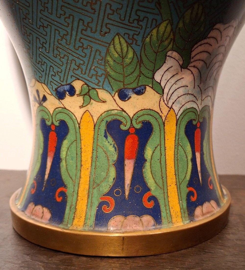 A large Chinese cloisonne enamel vase with pink and yellow floral motifs over a blue geometric ground and brass rim. View X