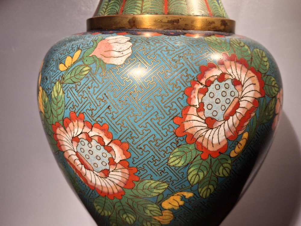 A large Chinese cloisonne enamel vase with pink and yellow floral motifs over a blue geometric ground and brass rim. View XI