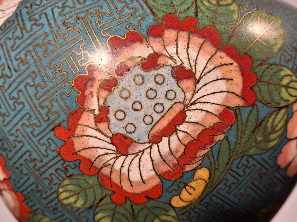 A large Chinese cloisonne enamel vase with pink and yellow floral motifs over a blue geometric ground and brass rim. View XIII