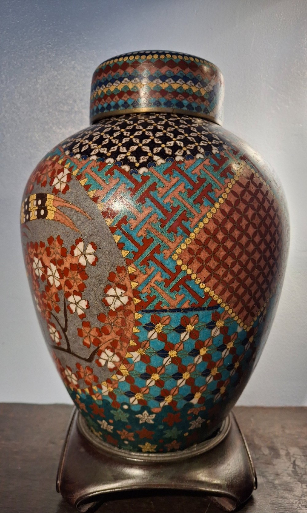 A nineteenth-century Japanese cloisonne enamel ginger jar featuring a patterned mosaic design and a colourful bird among floral motifs. View II