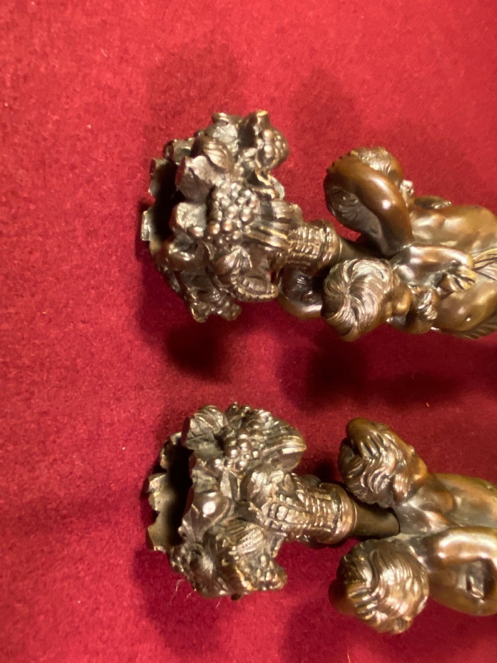 A pair of cast patinated bronze candlesticks featuring stems sculpted with putti figures and ornate stepped bases decorated with acanthus motifs. View III