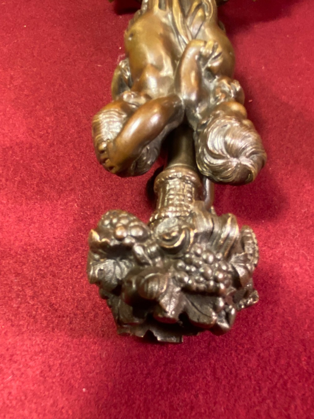 A pair of cast patinated bronze candlesticks featuring stems sculpted with putti figures and ornate stepped bases decorated with acanthus motifs. View IV
