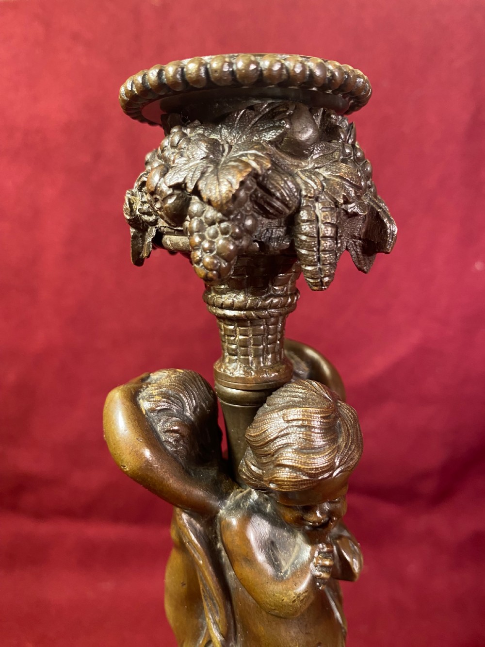 A pair of cast patinated bronze candlesticks featuring stems sculpted with putti figures and ornate stepped bases decorated with acanthus motifs. View XI
