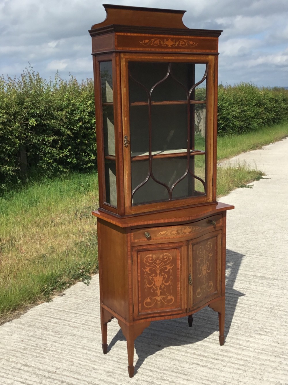 Fine Quality Inlaid display cabinet on serpentine cupboard base