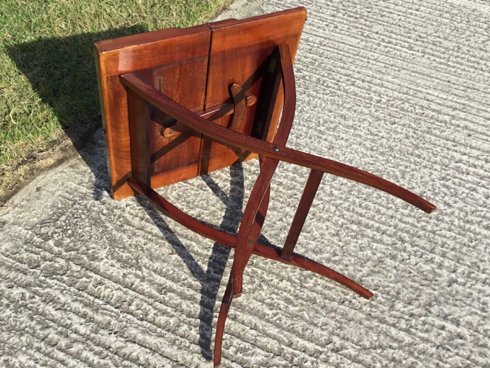 A mahogany folding coaching table with curved X-frame legs and a tray top design. View XI