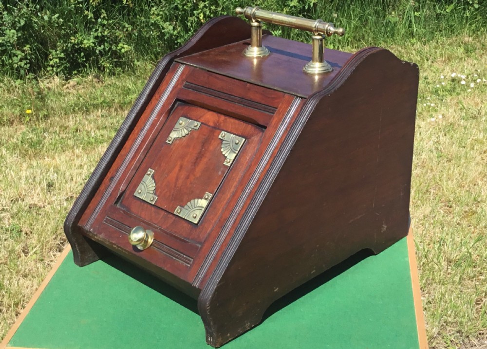 A Victorian dark mahogany coal purdonium featuring a sloped front hatch with brass corner plates, turned brass knob, and top brass bar handle. View X