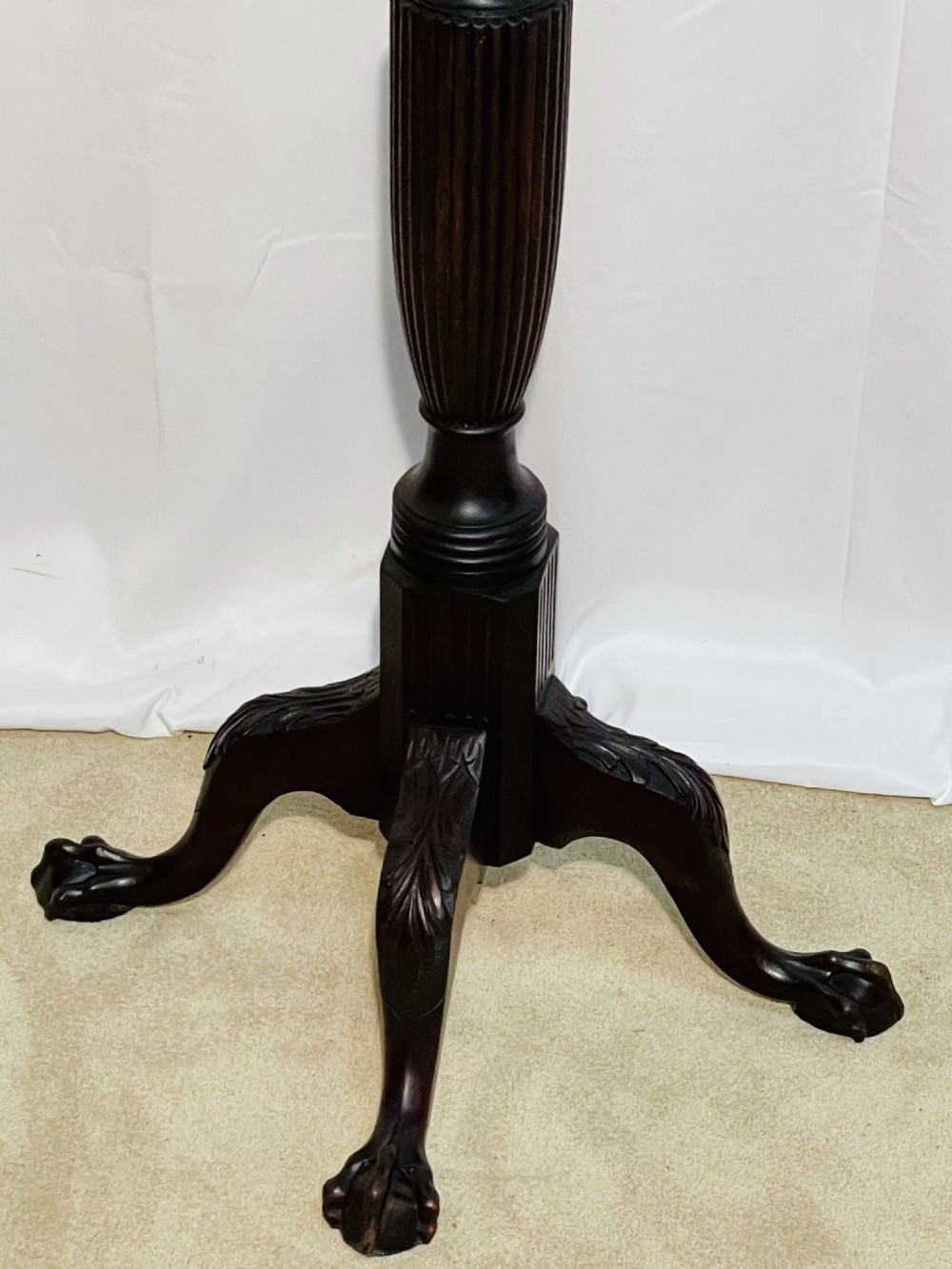 A tall dark mahogany torchere stand with a carved circular top, fluted central column, and tripod base with claw-and-ball feet. View VI