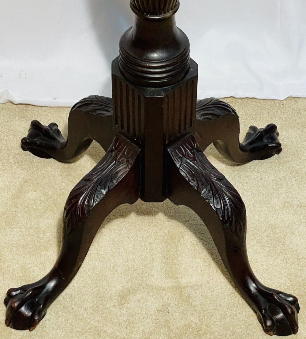 A tall dark mahogany torchere stand with a carved circular top, fluted central column, and tripod base with claw-and-ball feet. View XII