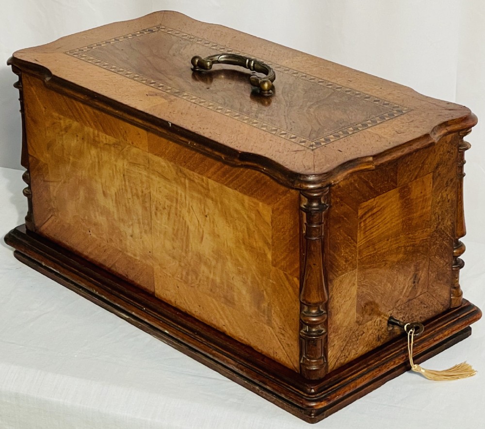 A late nineteenth-century black cast iron Gritzner sewing machine with floral decals mounted on an inlaid wooden base. View II