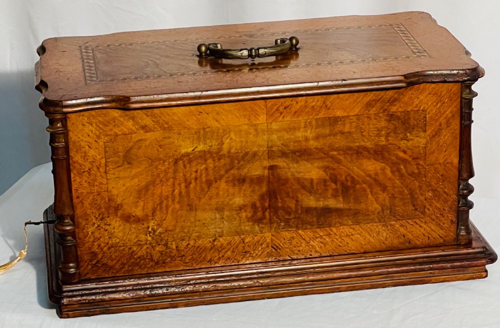A late nineteenth-century black cast iron Gritzner sewing machine with floral decals mounted on an inlaid wooden base. View VI
