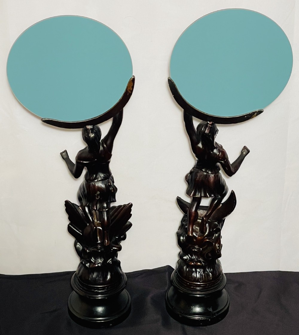 A pair of dark patinated spelter table mirrors featuring classical female figures standing on celestial-themed bases holding circular glass mirrors above their heads. View VIII