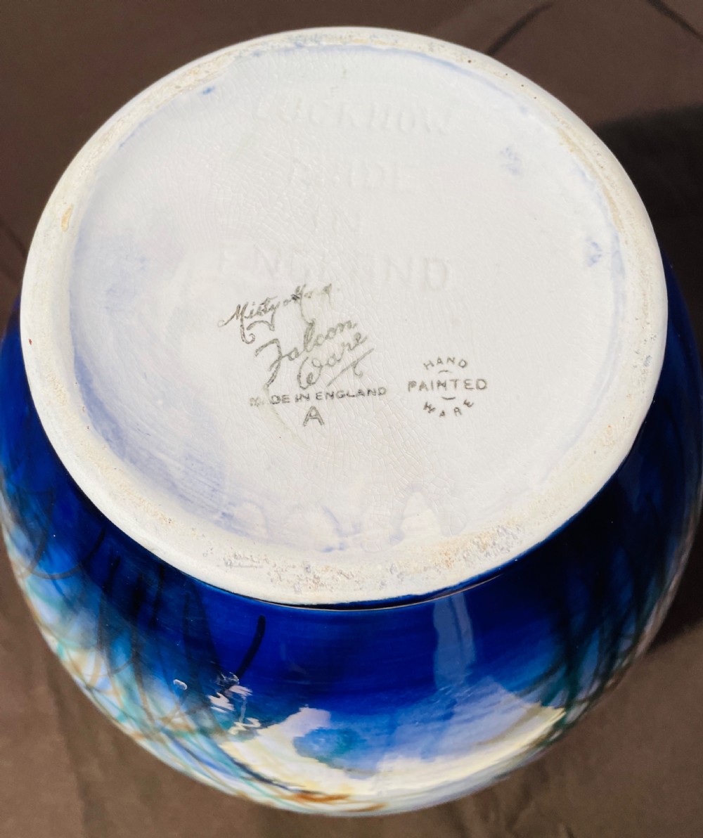 A round blue and grey ceramic vase depicting painted mallard ducks flying over water and reeds. View III