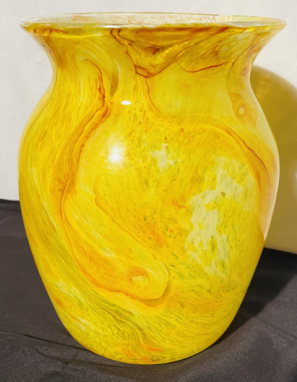 A flared 1930s Gray-Stan art glass vase featuring a swirling yellow and orange mottled pattern.