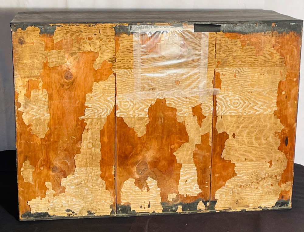 A taxidermy Eurasian otter positioned on a simulated rocky embankment with dried grasses, contained within a glass-panelled display case. View XII